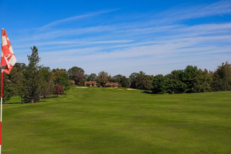 A photo of the Hideaway Hills golf course with 3 cabins