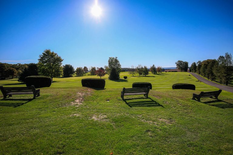 A photo of the sun shining on the Hideaway Hills golf course