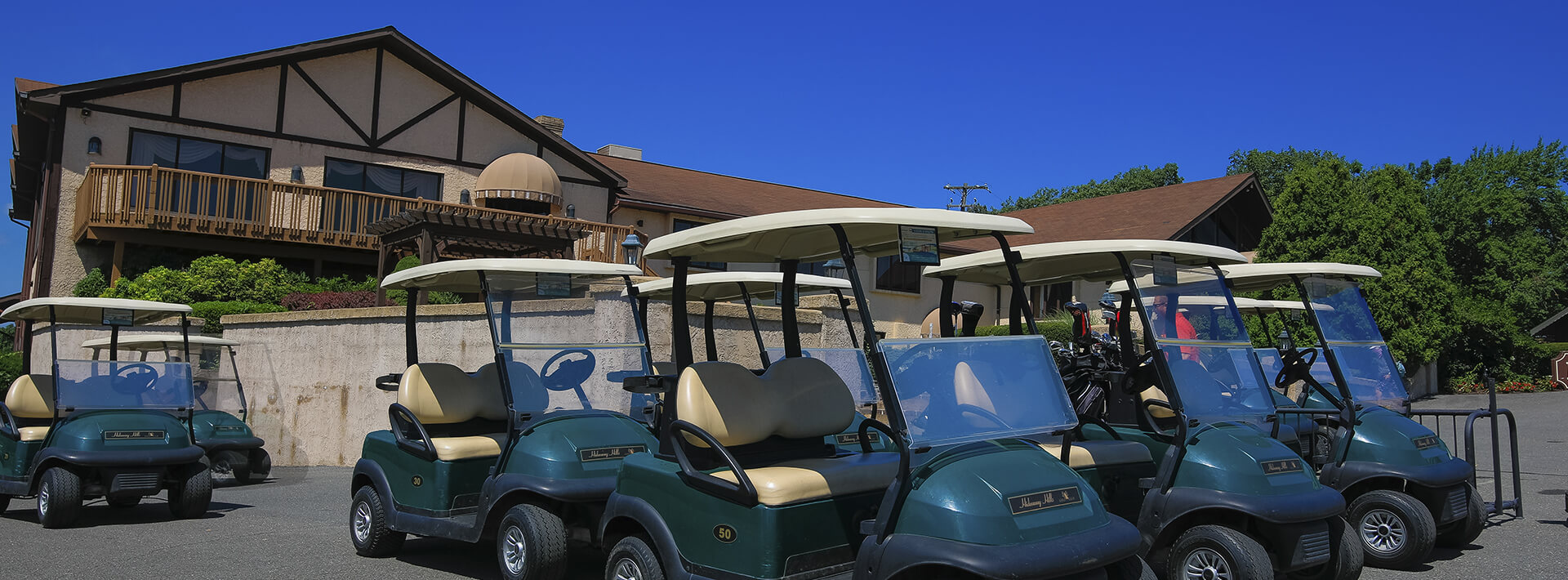 A photo of the Hideaway Hills golf club with parked golf carts